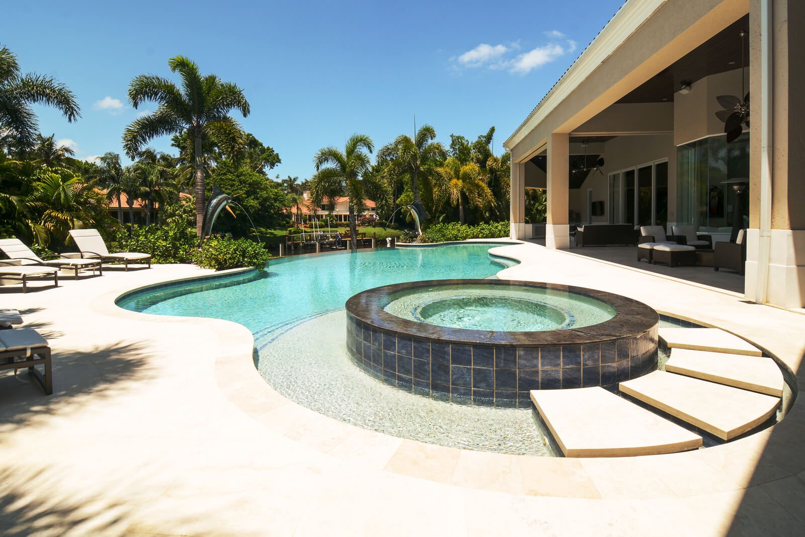 Various pool deck materials including travertine and natural stone options in Jensen Beach, Florida